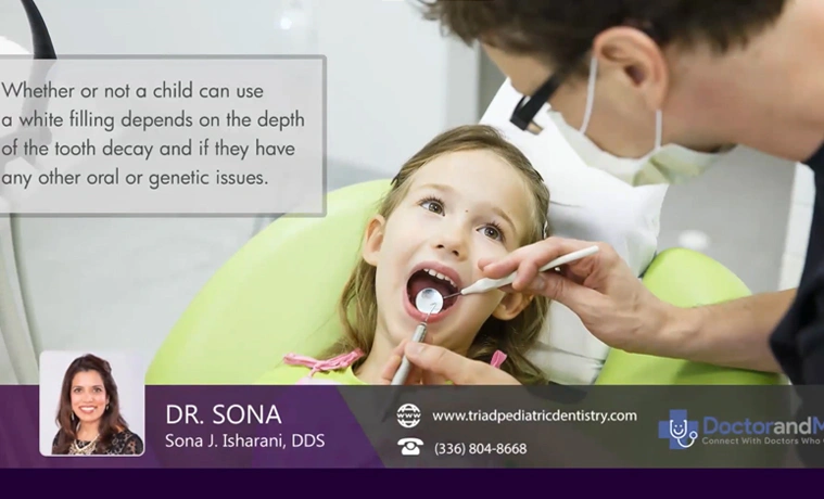 Pediatric dentist examining young child's teeth in dental office with parent present.
