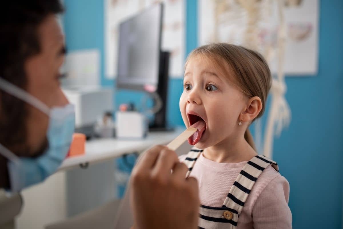 Young girl with open mouth during dental examination at Greensboro pediatric dentist office.